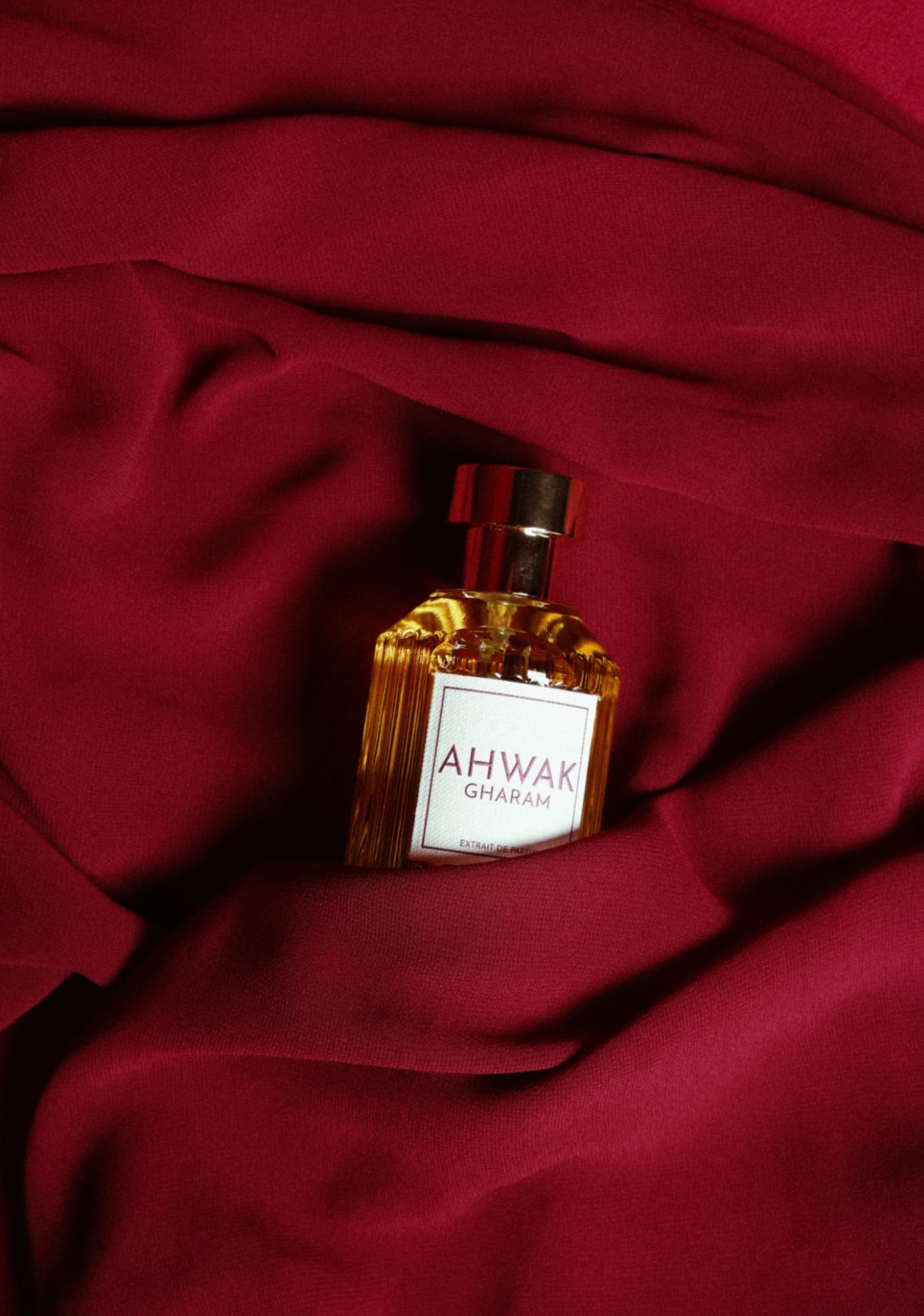 Perfume bottle resting in red fabric