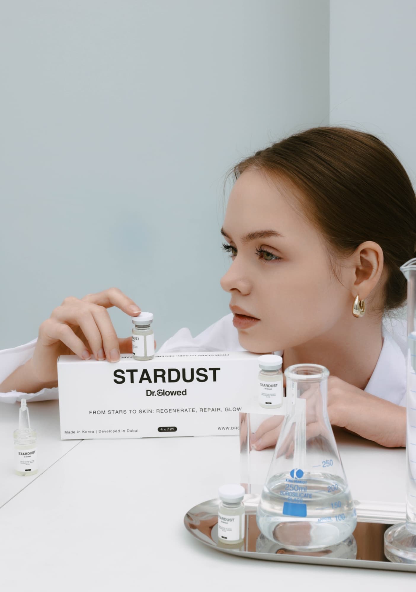 Woman in a lab setting presenting Stardust skincare